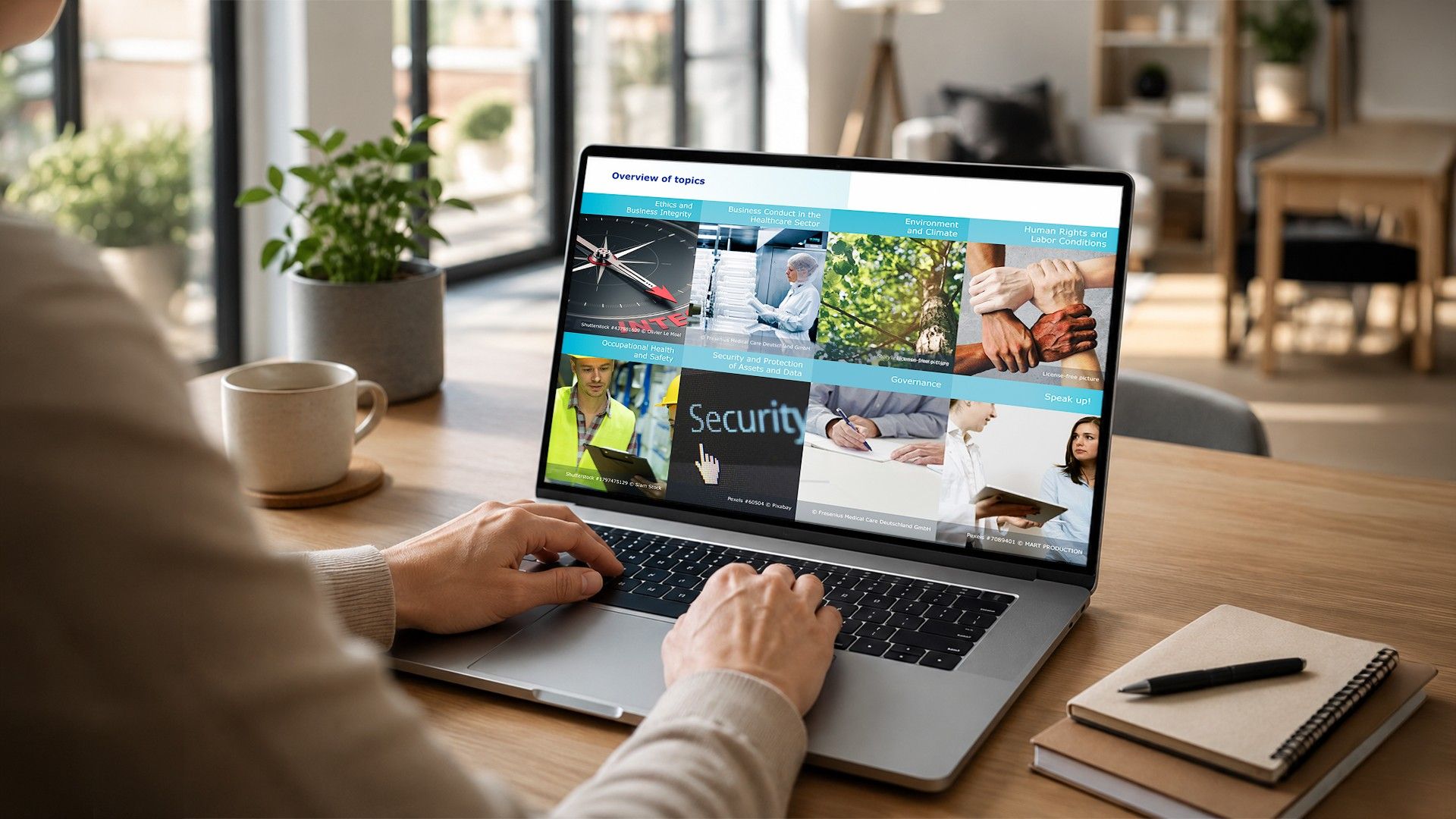 using a laptop displaying an overview of workplace compliance and security training topics.